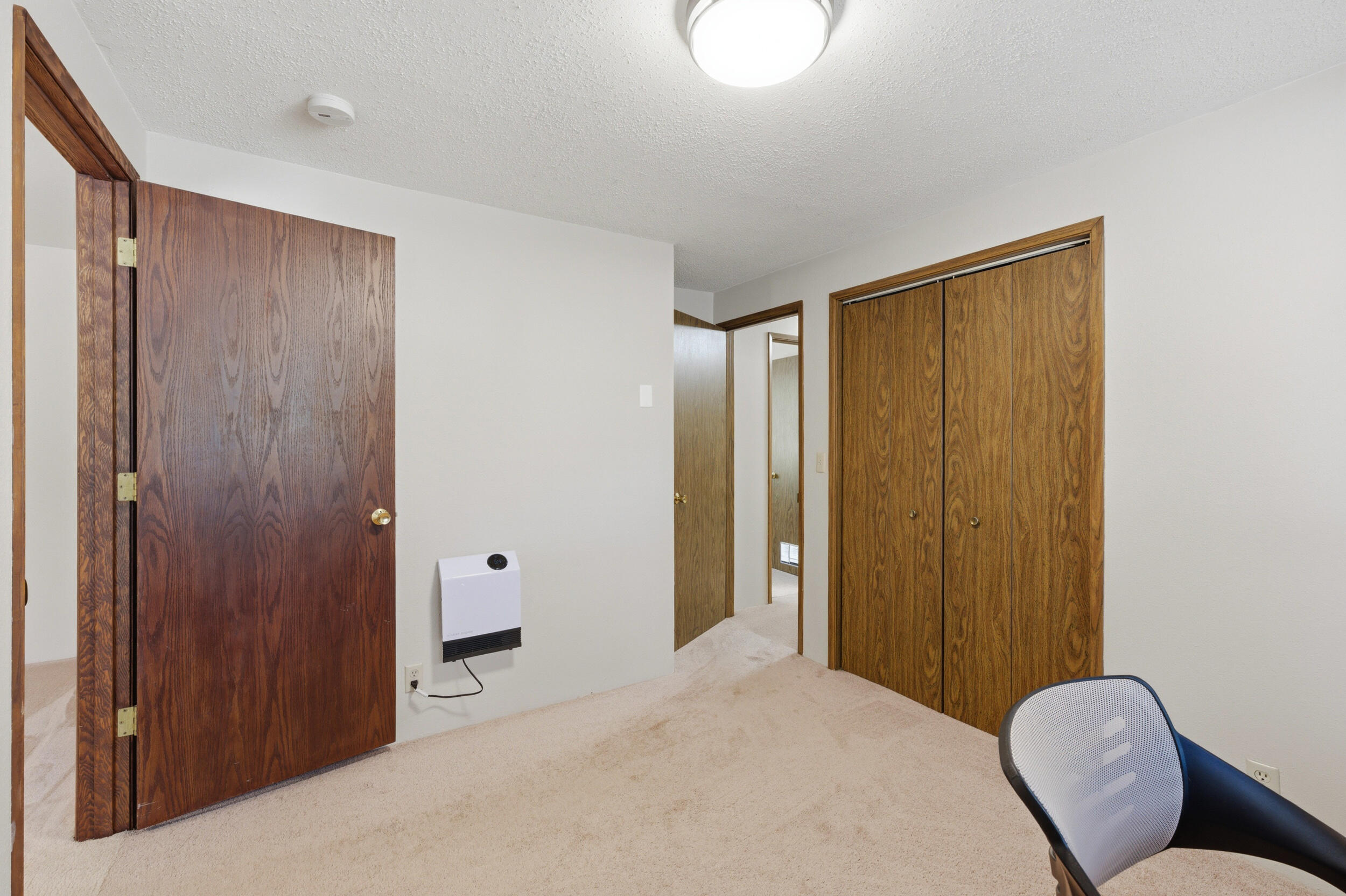 50868 Doe Loop La Pine, OR 97739 - Photo 26 of 51 a bedroom with a bed closet and wooden floor