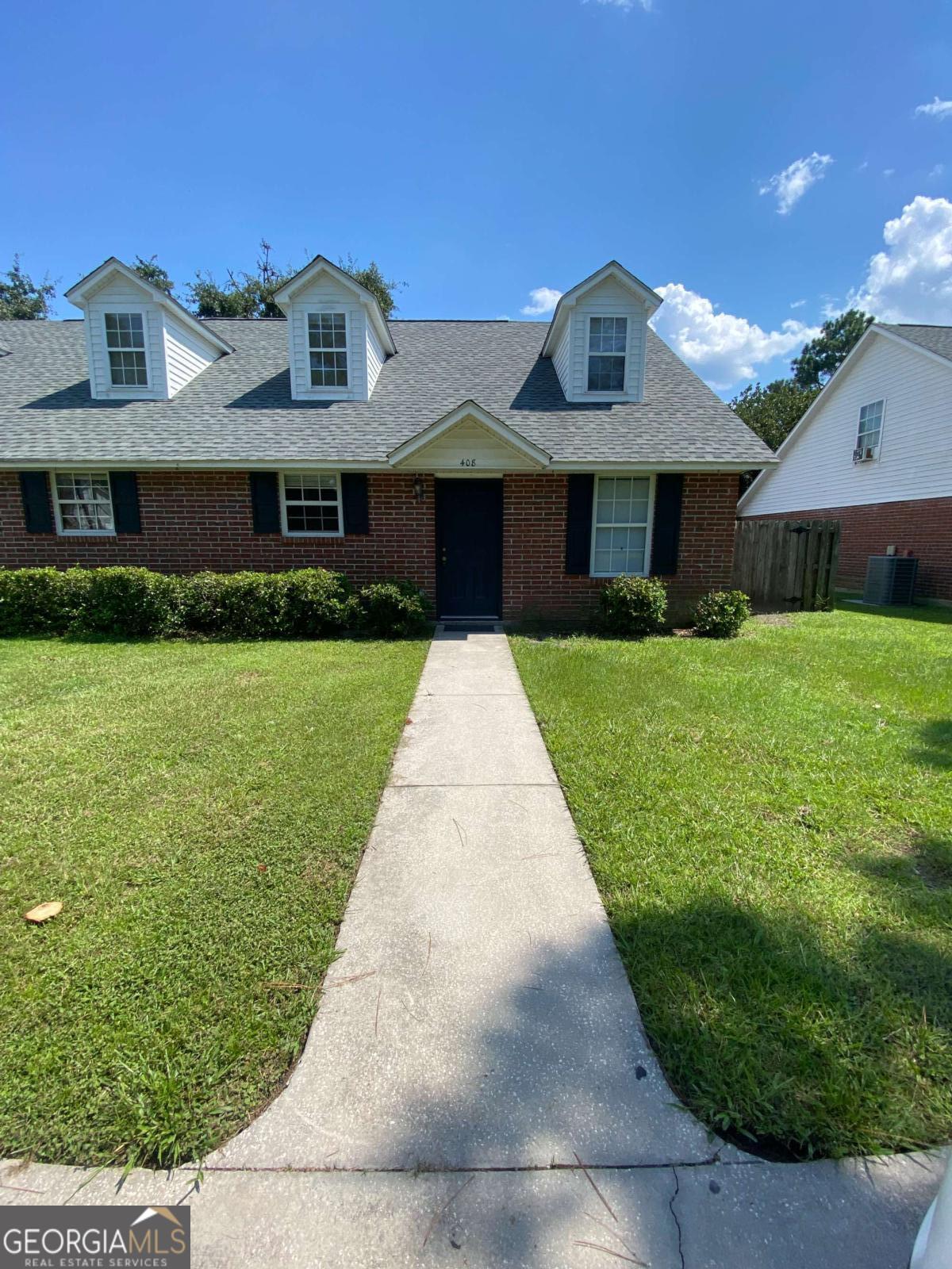 a front view of a house with yard