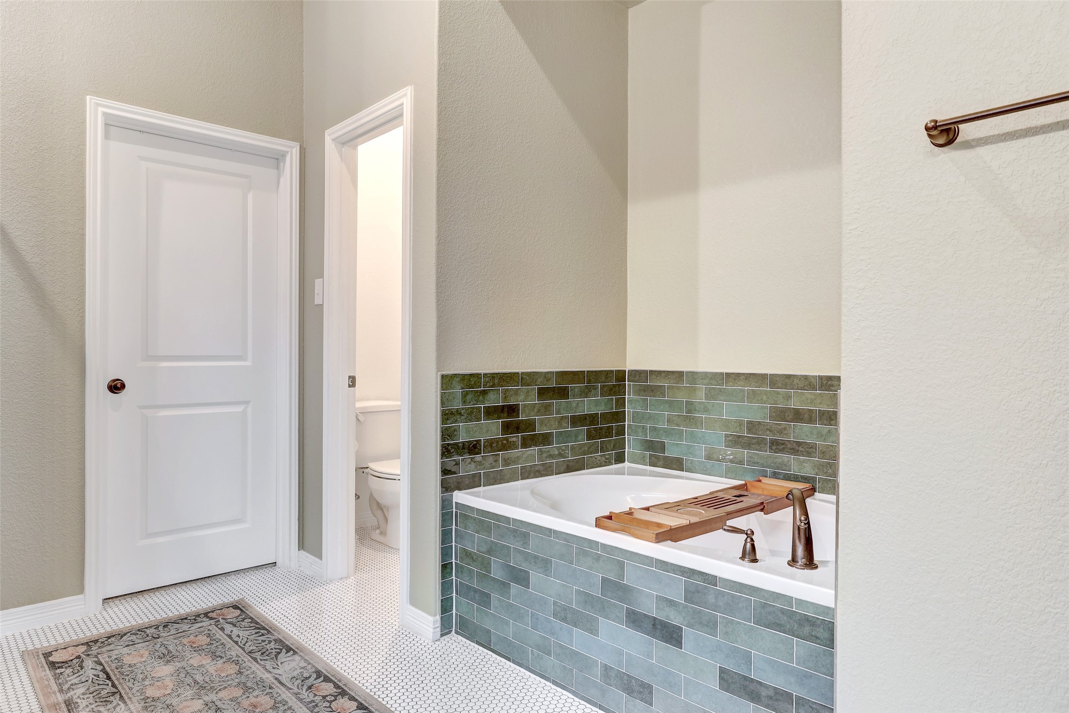 1117 Spring Gulch Lane Georgetown, TX 78628 - Photo 27 of 39 Indulge in a tranquil bathing experience with this deep soaking tub, elegantly encased in glazed subway tile.
