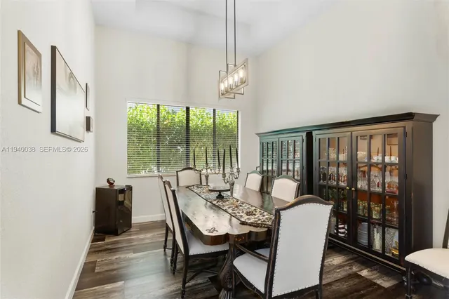 a view of a dining room with furniture large windows and wooden floor