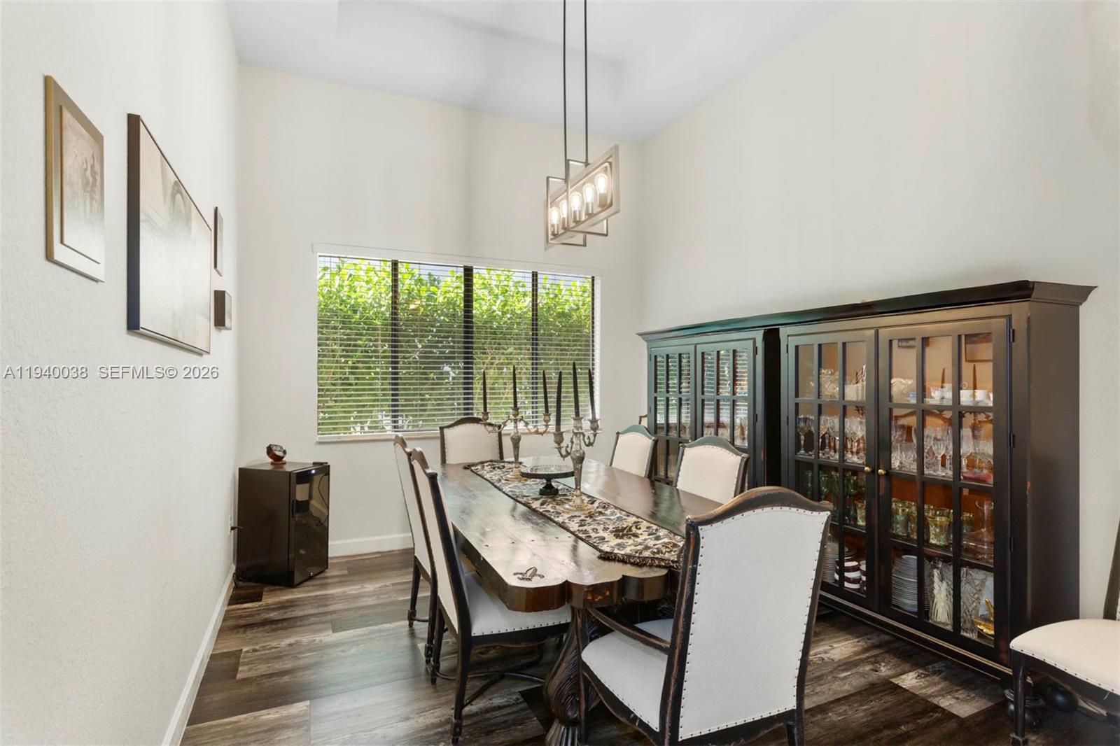 7666 Southwest 193rd Lane Cutler Bay, FL 33157 - Photo 13 of 45 a view of a dining room with furniture large windows and wooden floor