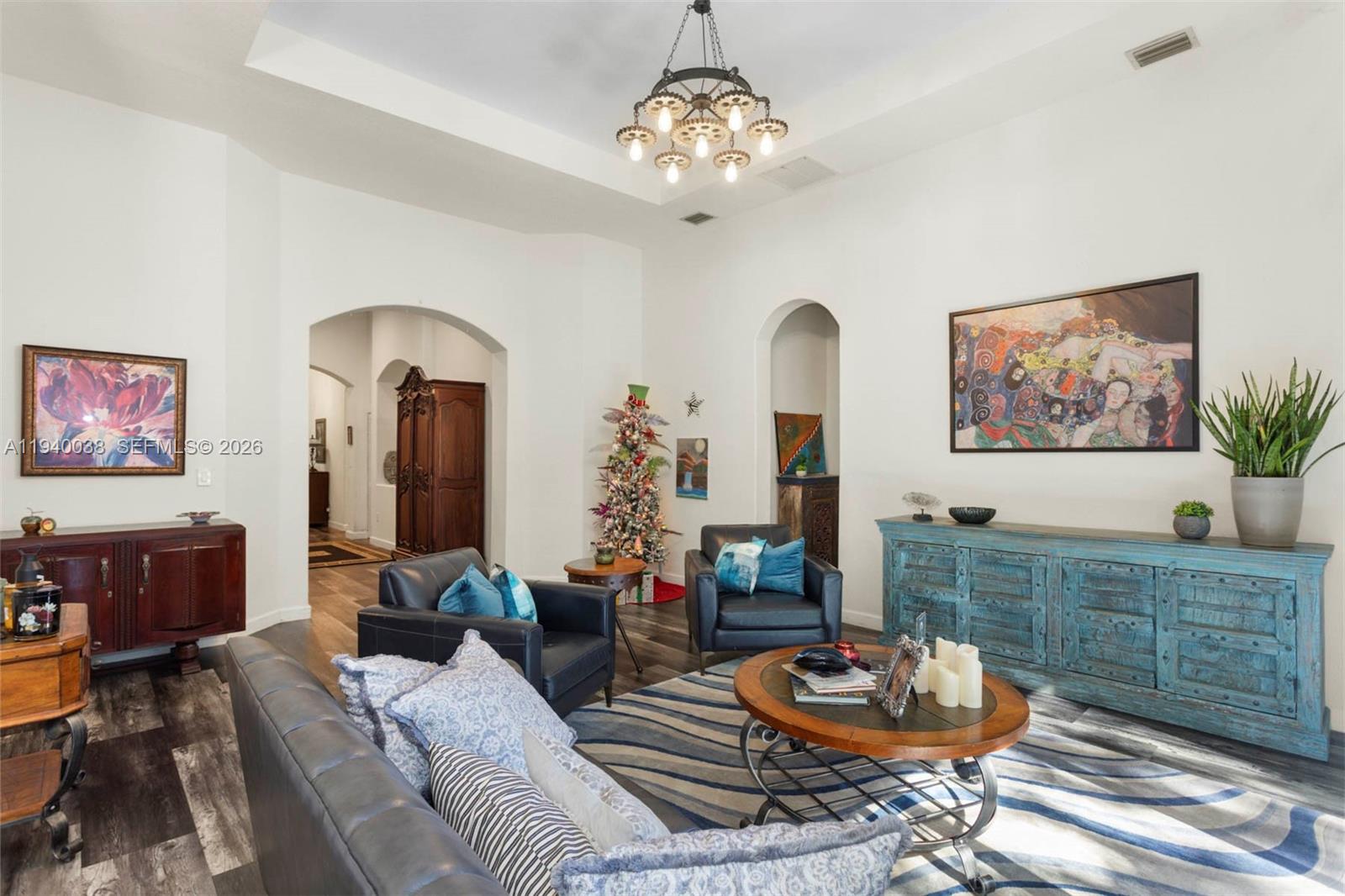 7666 Southwest 193rd Lane Cutler Bay, FL 33157 - Photo 16 of 45 a living room with furniture and a chandelier