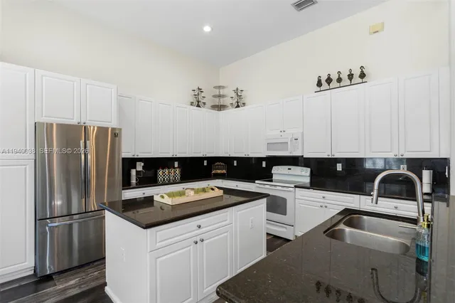 a kitchen with a sink cabinets and stainless steel appliances