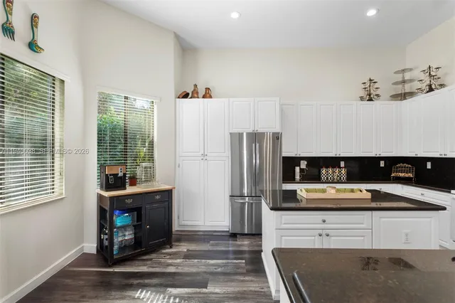 a kitchen with stainless steel appliances a refrigerator sink and cabinets