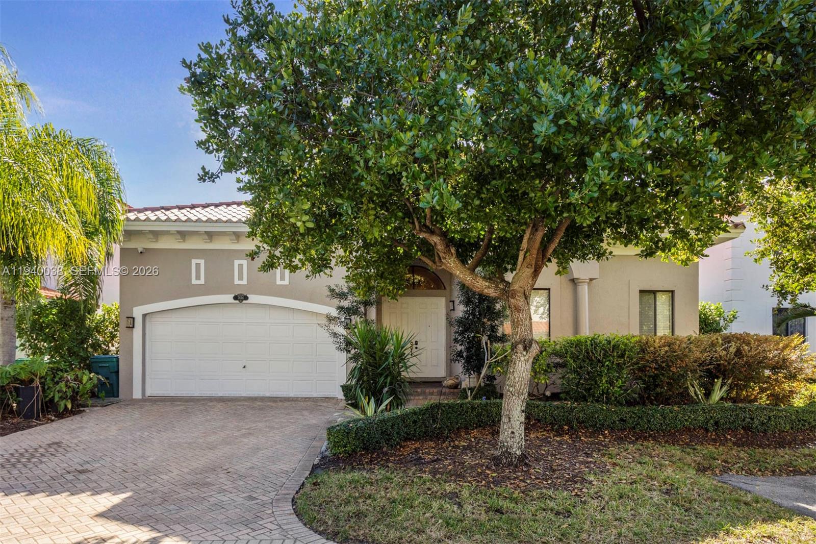 7666 Southwest 193rd Lane Cutler Bay, FL 33157 - Photo 2 of 45 a front view of a house with garden