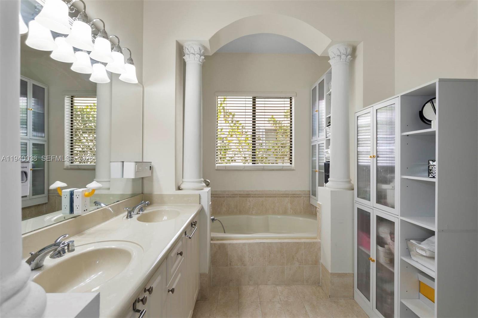 7666 Southwest 193rd Lane Cutler Bay, FL 33157 - Photo 22 of 45 a bathroom with a tub sink and mirror