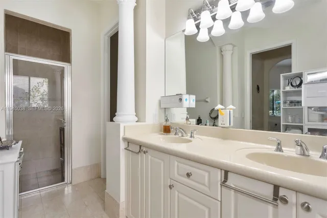 a bathroom with a sink vanity granite and a mirror