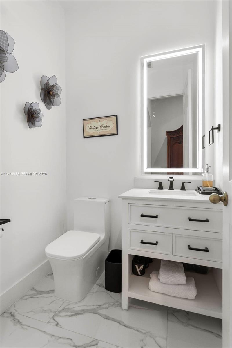 7666 Southwest 193rd Lane Cutler Bay, FL 33157 - Photo 25 of 45 a bathroom with a sink mirror and toilet