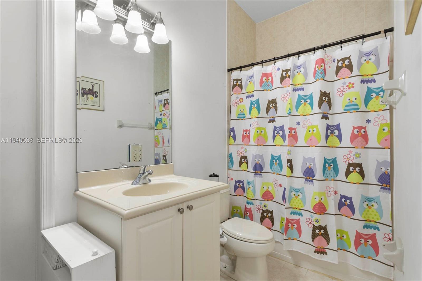 7666 Southwest 193rd Lane Cutler Bay, FL 33157 - Photo 30 of 45 a bathroom with a sink a toilet and a shower curtain