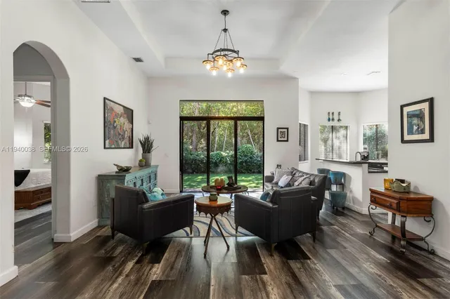 a living room with furniture and a chandelier