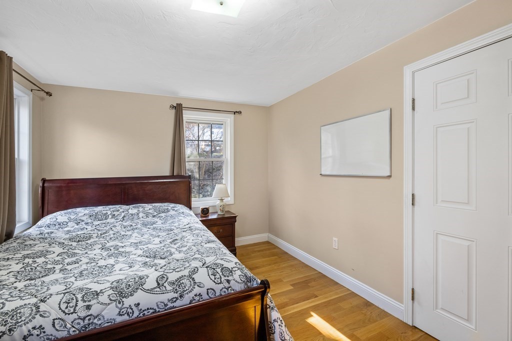 11 Spring Road, Unit B Arlington, MA 02476 - Photo 12 of 19 a bedroom with a bed and dresser