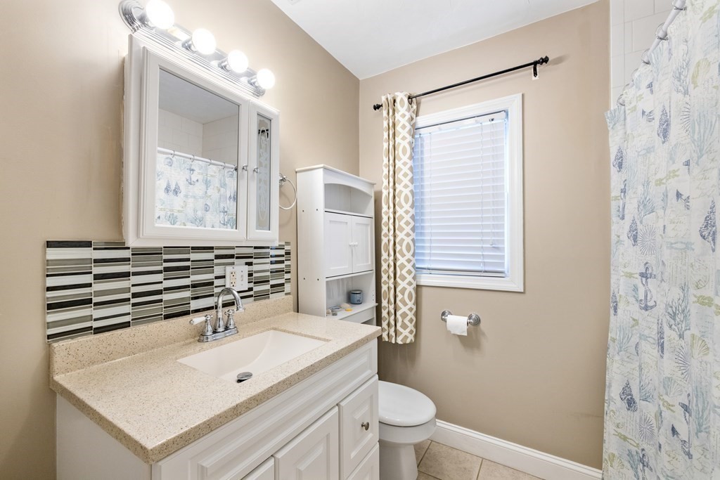 11 Spring Road, Unit B Arlington, MA 02476 - Photo 13 of 19 a bathroom with a sink a toilet and shower