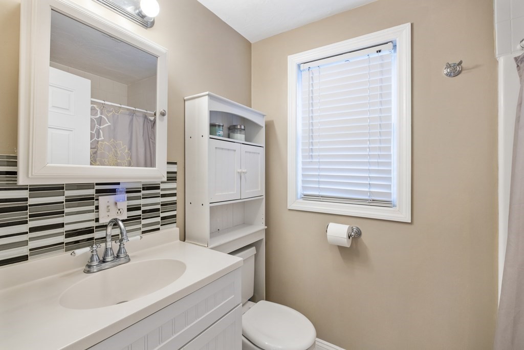 11 Spring Road, Unit B Arlington, MA 02476 - Photo 14 of 19 a bathroom with a sink toilet and mirror