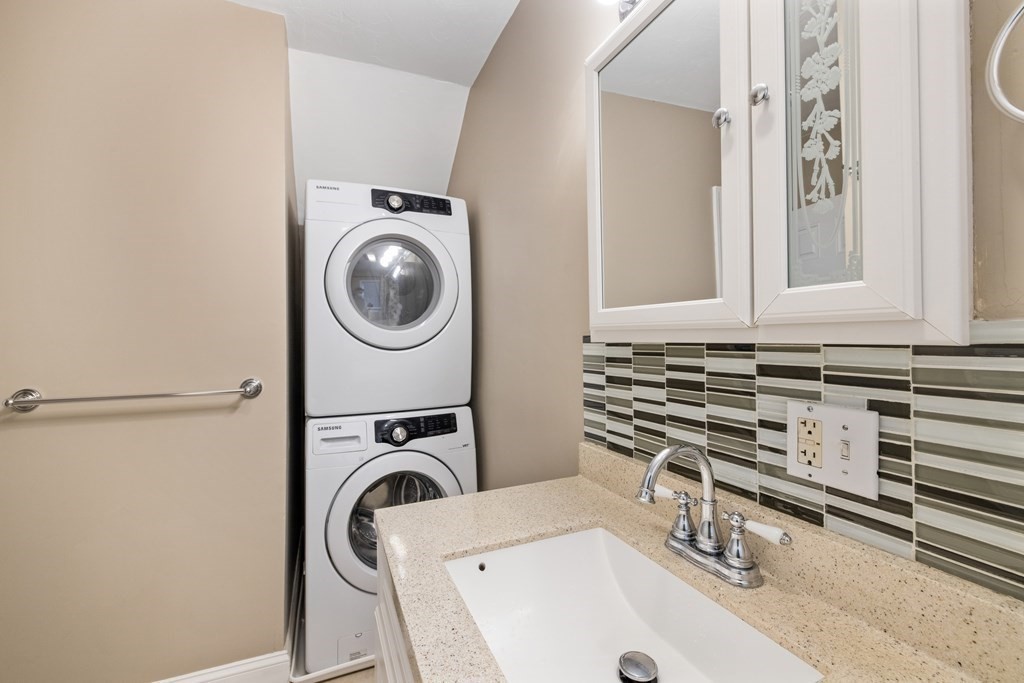 11 Spring Road, Unit B Arlington, MA 02476 - Photo 15 of 19 a bathroom with a sink a mirror and a window