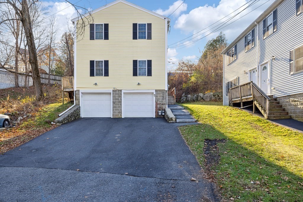 11 Spring Road, Unit B Arlington, MA 02476 - Photo 18 of 19 a view of a white house with a yard and a large tree
