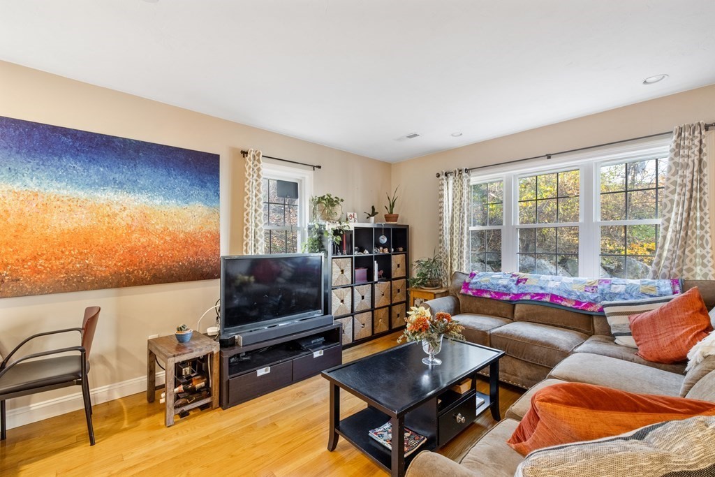 11 Spring Road, Unit B Arlington, MA 02476 - Photo 2 of 19 a living room with furniture and a flat screen tv
