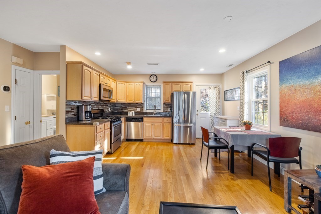 11 Spring Road, Unit B Arlington, MA 02476 - Photo 5 of 19 a living room with stainless steel appliances kitchen island granite countertop furniture and a dining table