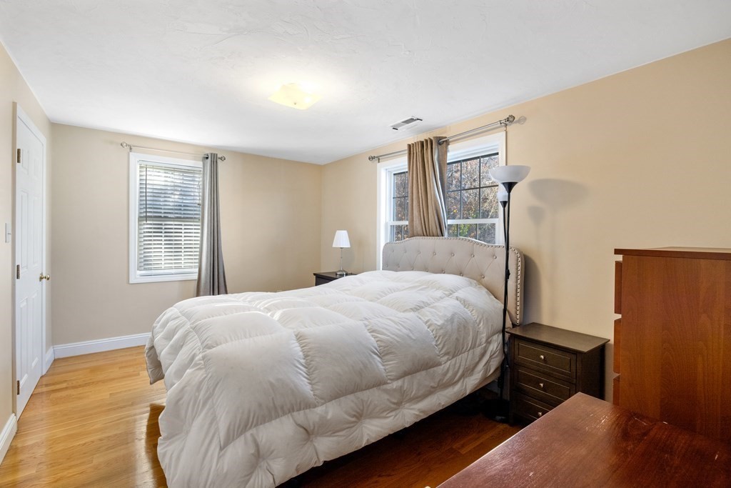 11 Spring Road, Unit B Arlington, MA 02476 - Photo 9 of 19 a bedroom with a bed and wooden floor