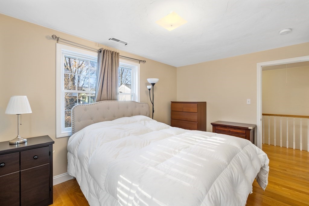 11 Spring Road, Unit B Arlington, MA 02476 - Photo 10 of 19 a bedroom with a bed and a lamp