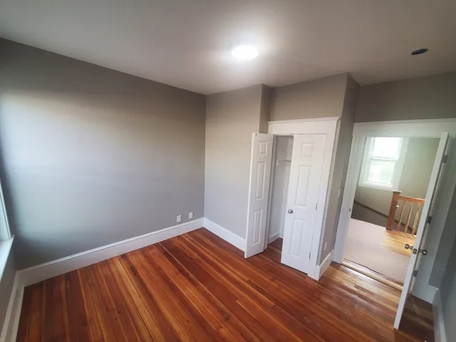 a view of a room with wooden floor