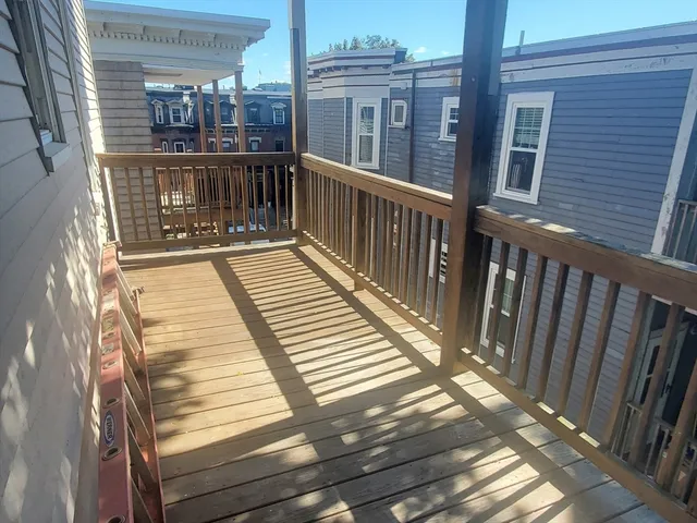 a view of a balcony with wooden floor