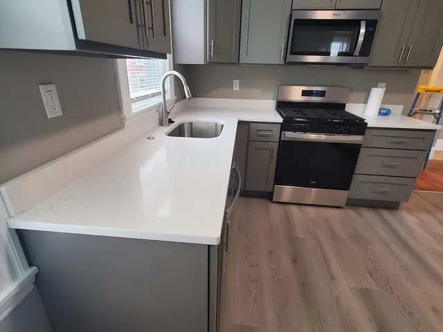 a kitchen with a sink and a stove top oven
