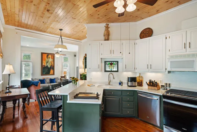 a kitchen with stainless steel appliances granite countertop a refrigerator and a stove