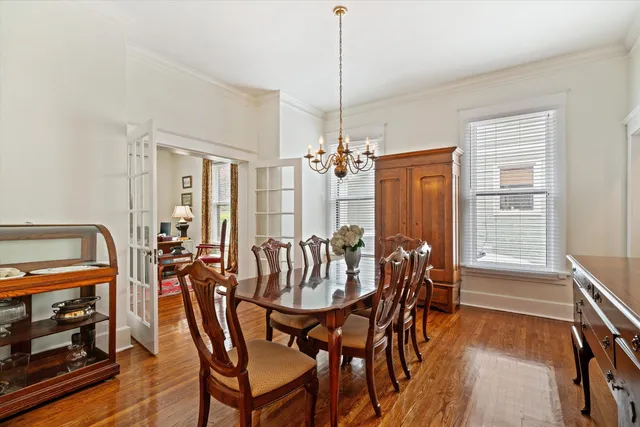 a view of a dining room with furniture wooden floor and chandelier