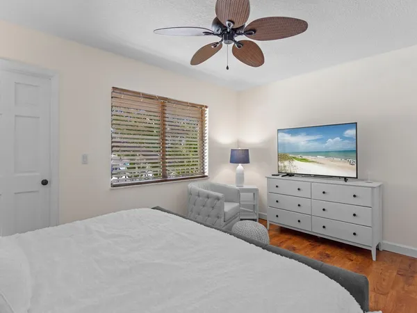a bedroom with a bed and a flat screen tv