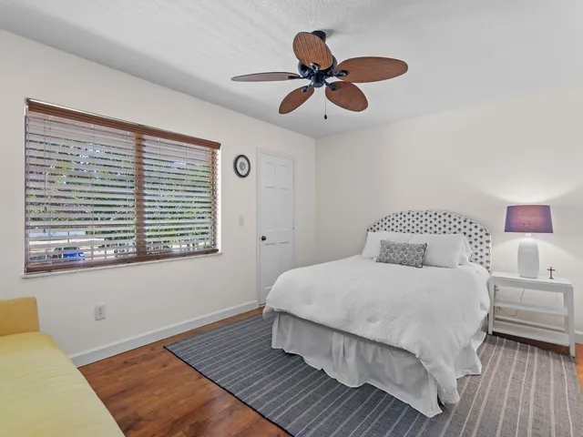 a bedroom with a large bed and a window