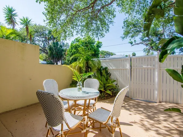 a view of a chairs and table in backyard