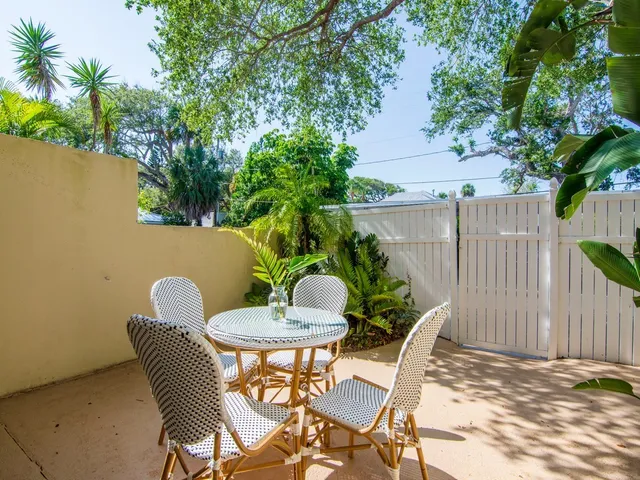 a view of a chairs and table in backyard