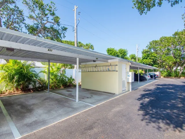 a view of a house with a big yard and potted plants