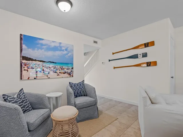 a living room with furniture and white walls