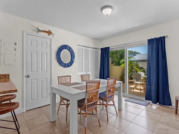 a dining room with furniture and a window