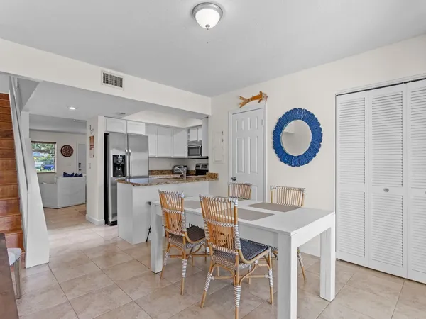 a kitchen with a refrigerator and a stove top oven