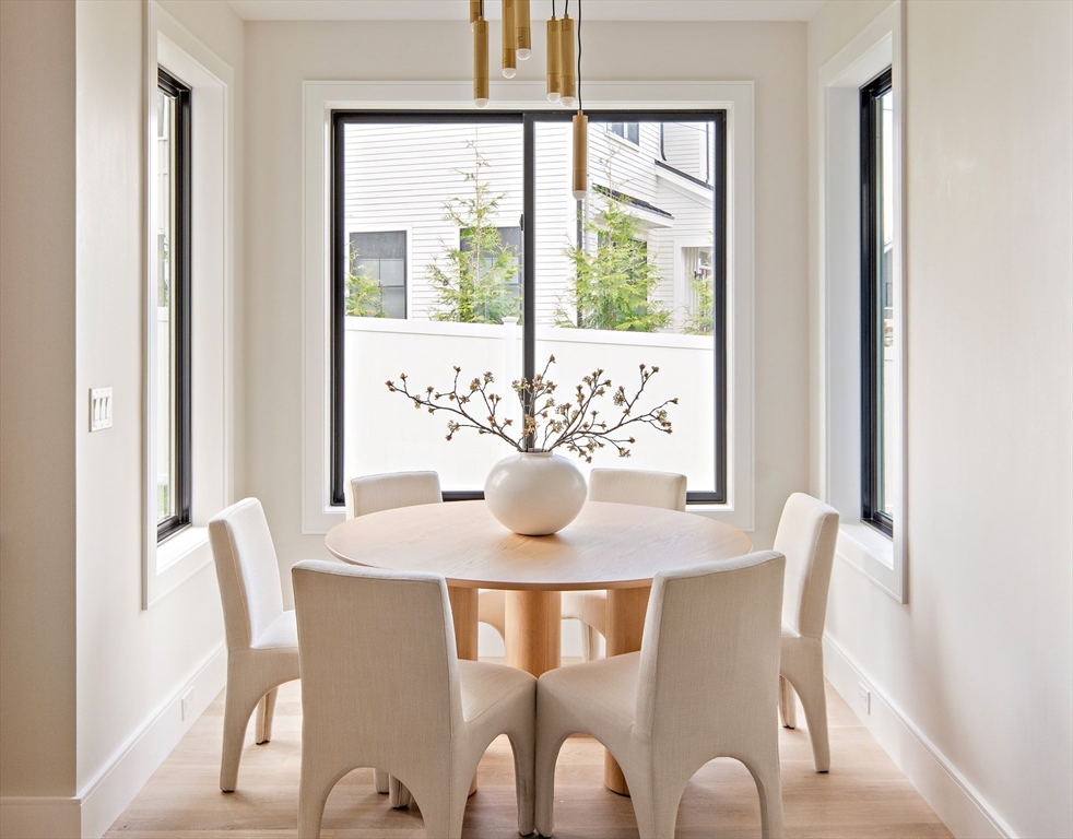 34 Pershing Road Needham, MA 02494 - Photo 13 of 41 a view of a dining room with furniture a potted plant and a chandelier