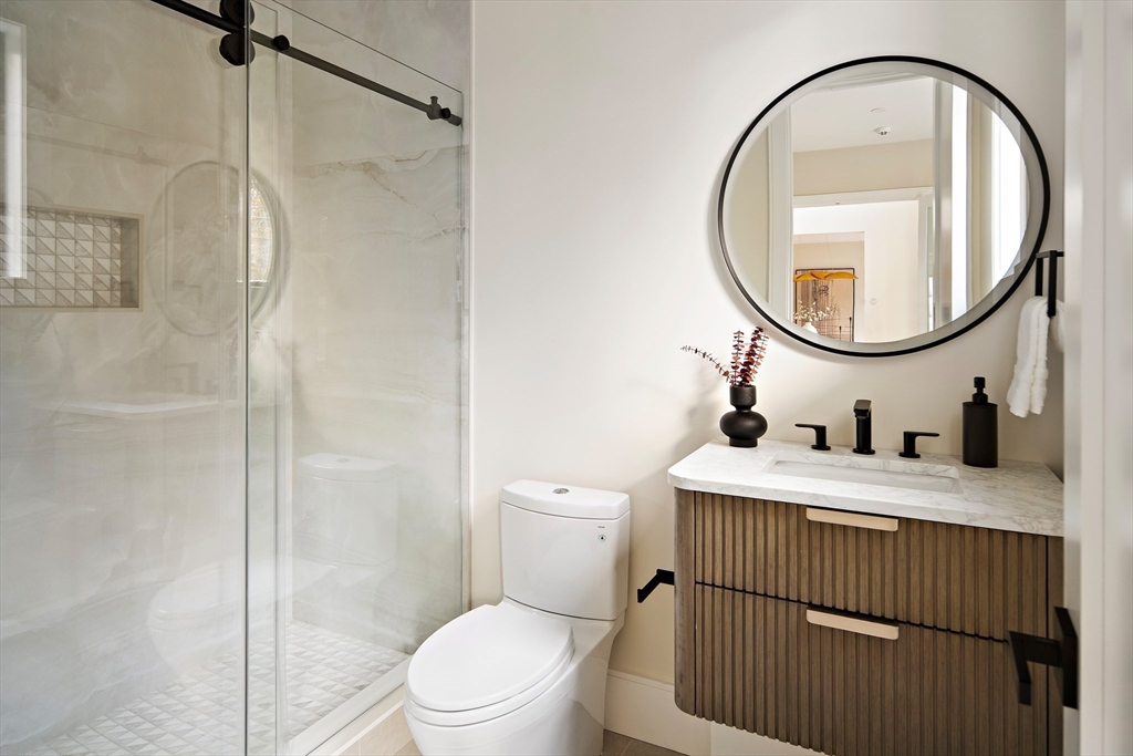 34 Pershing Road Needham, MA 02494 - Photo 21 of 41 a bathroom with a granite countertop sink a toilet and a mirror