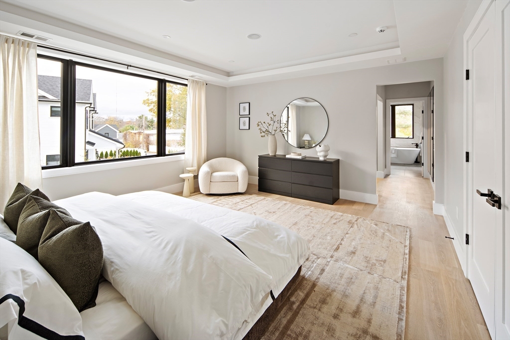 34 Pershing Road Needham, MA 02494 - Photo 23 of 41 a bedroom with a large bed and wooden floor