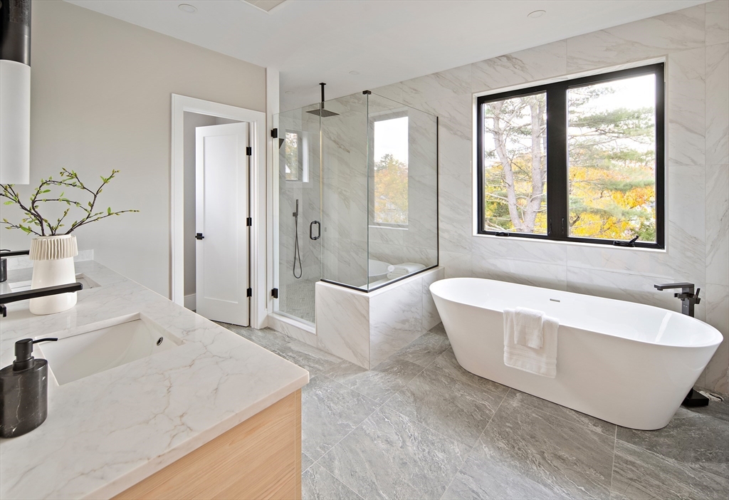 34 Pershing Road Needham, MA 02494 - Photo 25 of 41 a bathroom with a tub a sink and a large mirror
