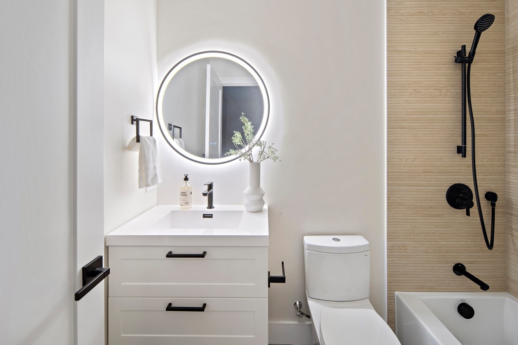 34 Pershing Road Needham, MA 02494 - Photo 32 of 41 a bathroom with a sink a toilet and a mirror