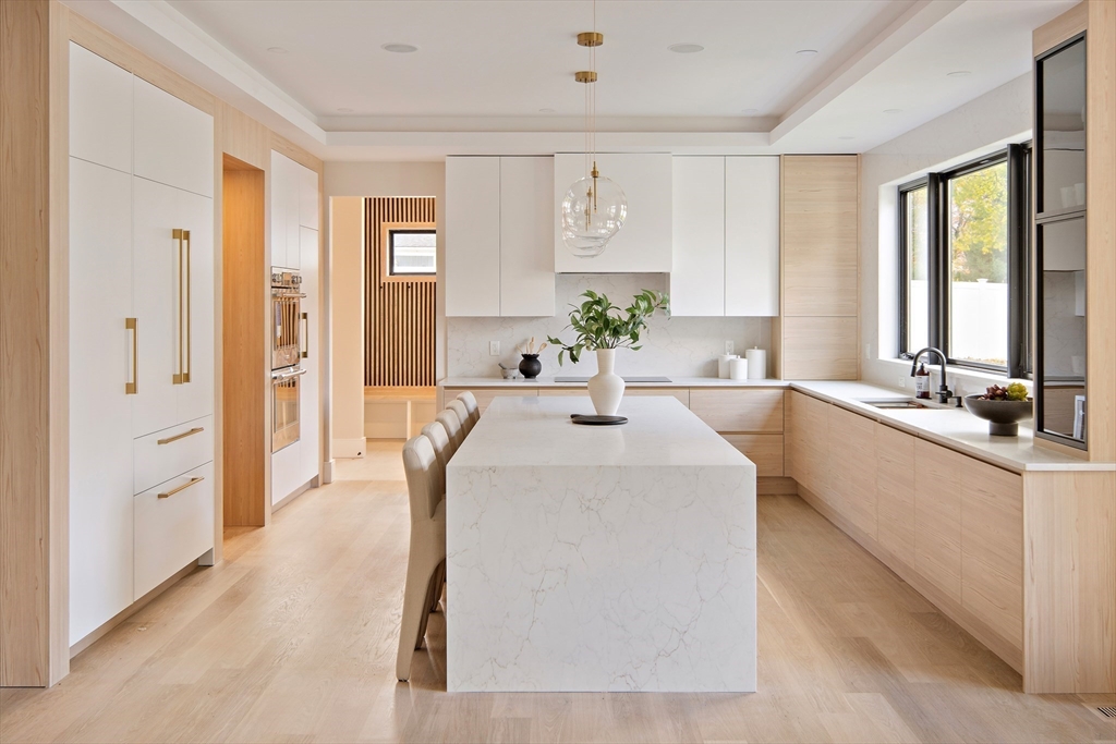 34 Pershing Road Needham, MA 02494 - Photo 7 of 41 a large white room with a large window and wooden floor