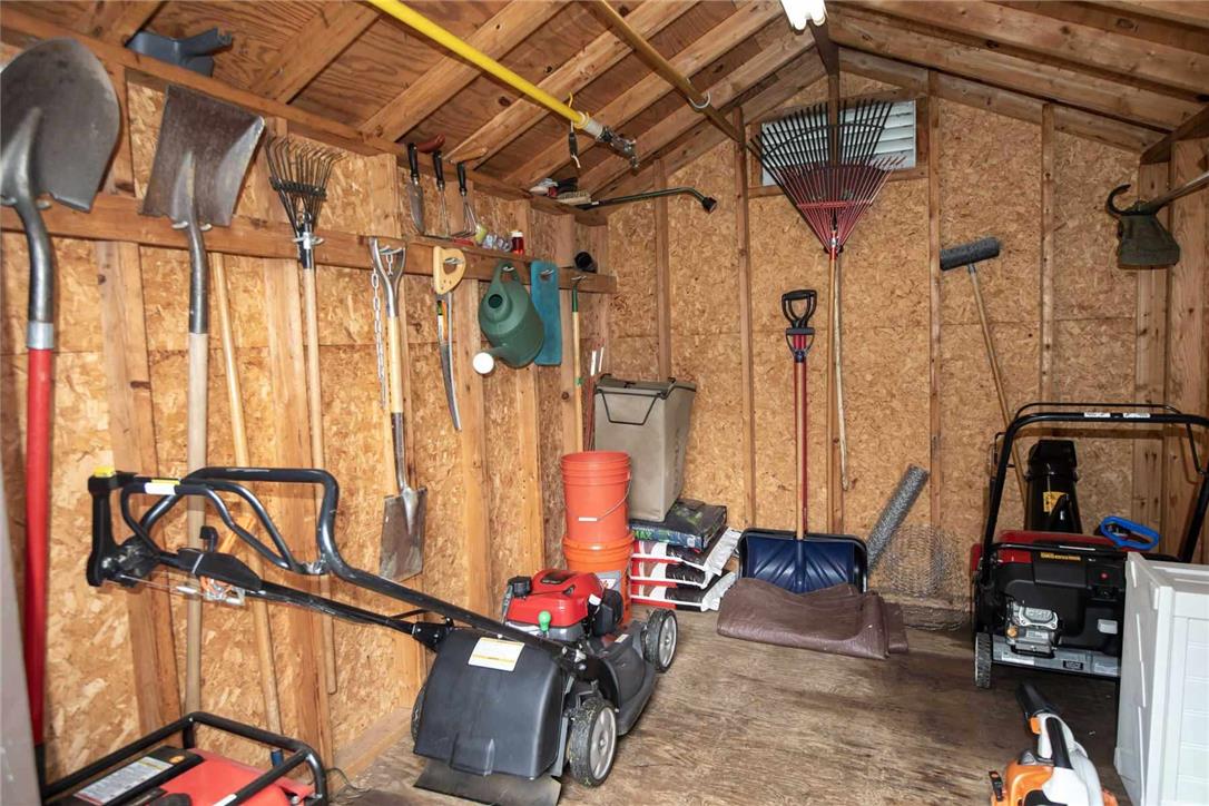 706 Stones Crossing Road Easton, PA 18045 - Photo 35 of 40 Essential garden tools and machinery are neatly arranged in this functional storage shed.