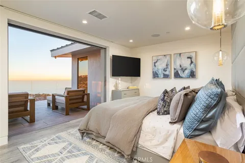 a bedroom with a bed a couch and dresser