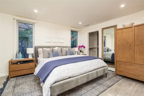 a spacious bedroom with a bed and a couch