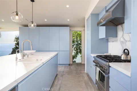 a kitchen that has a sink and a stove in it