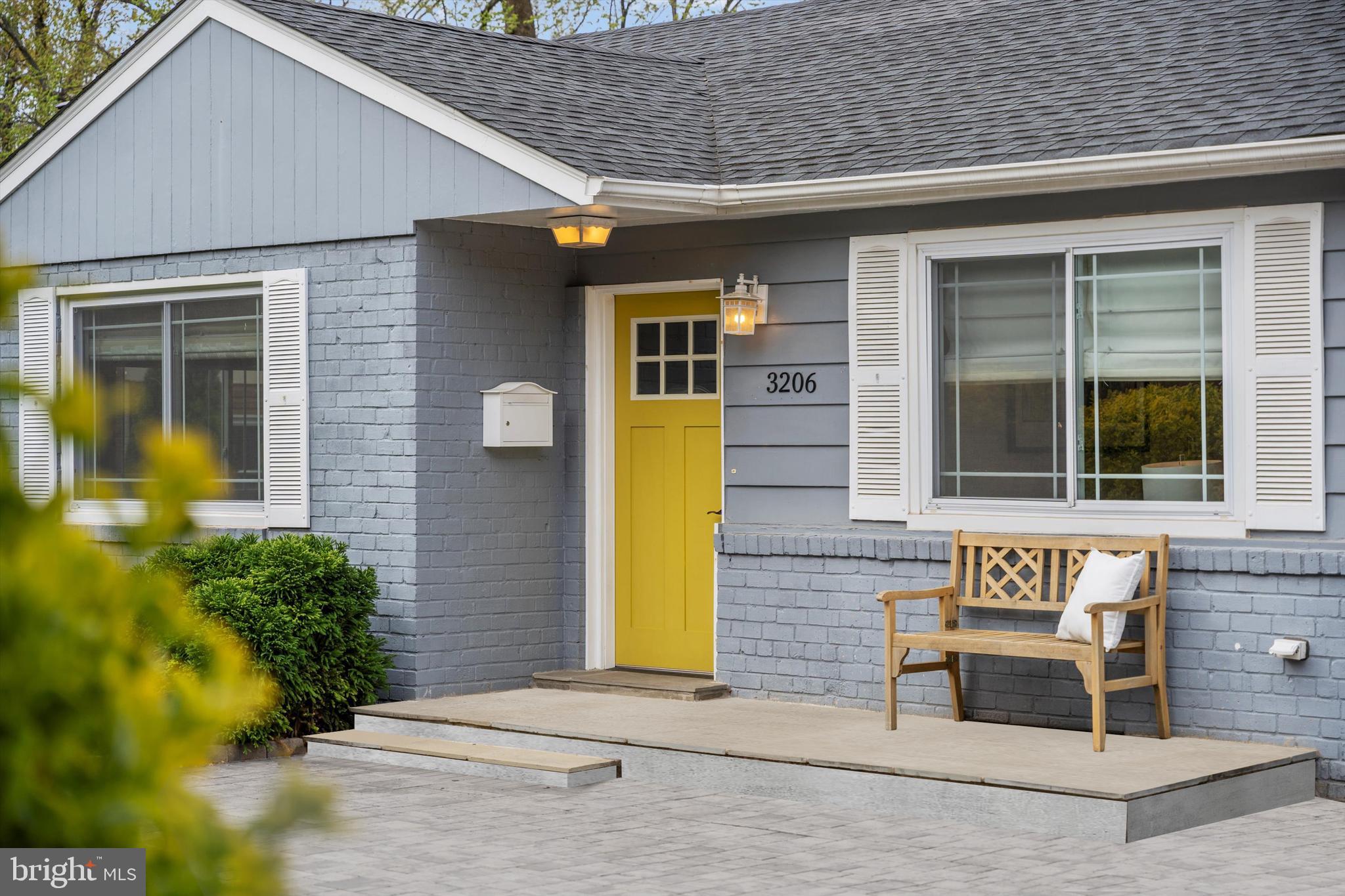3206 North Glebe Road Arlington, VA 22207 - Photo 2 of 20 a view of a brick house with potted plants and a table and chair