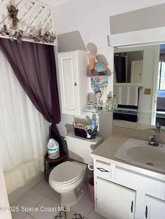 a bedroom with a bed and large window