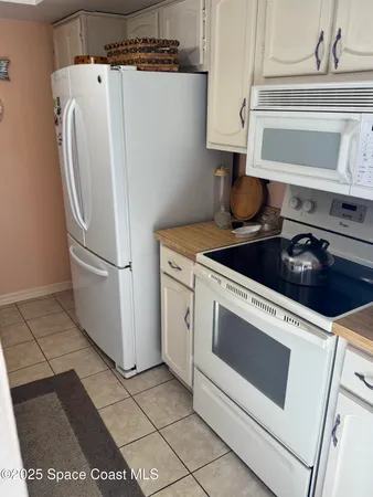 a view of a balcony with chairs and wooden floor