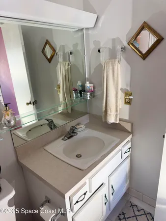 a bathroom with a sink toilet and mirror